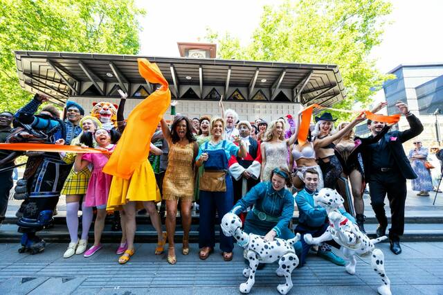 Zoe Birkett Mazz Murray cut the ribbon with fellow West End cast members at the reopening of the Official London Theatre Ticket Booth c Ghelani Studios 1